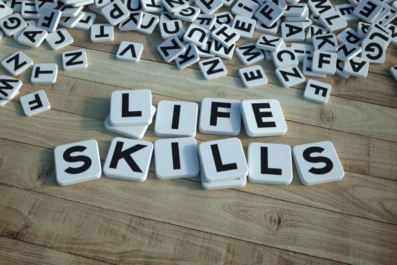 3d rendering of the words life skills written on letter tiles against a wooden background