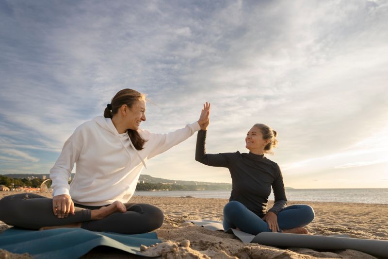 Mother and daughter doing yoga full shot